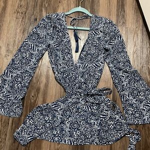 Super cute and sexy wrap dress. Low front and low back. Never worn. Size small